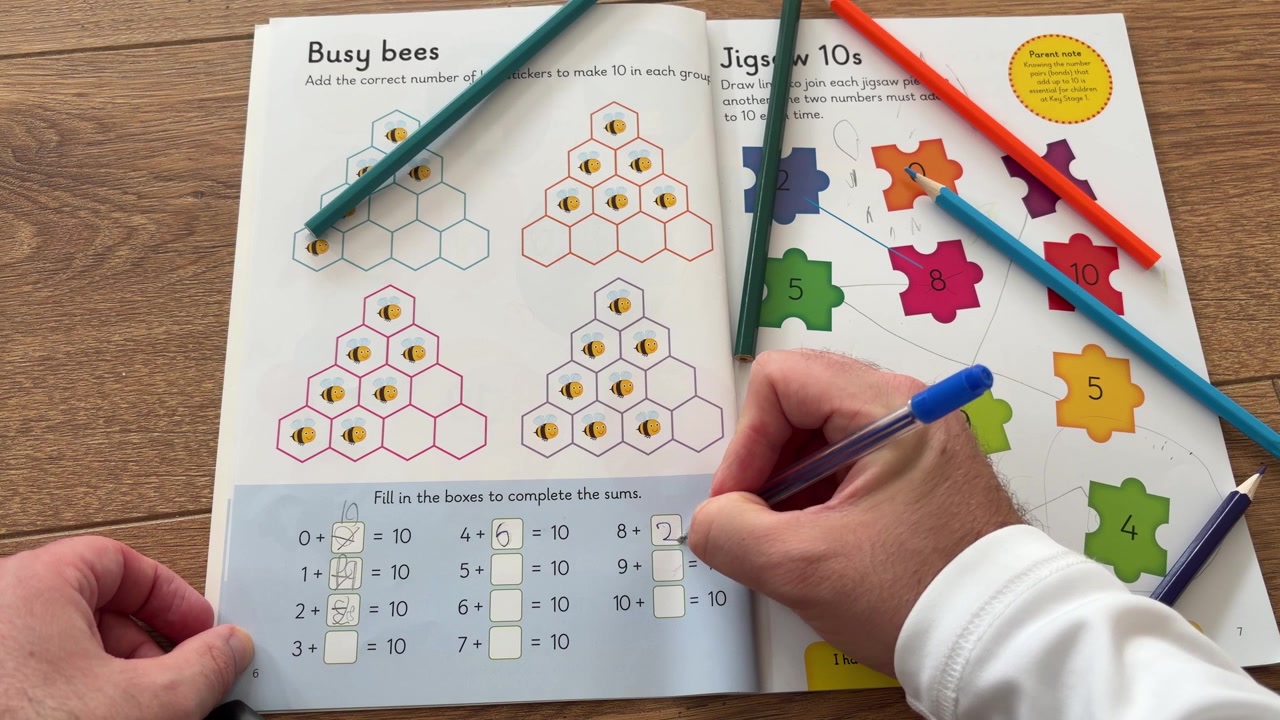 Child Completing a Colourful Educational Activity Workbook at Home