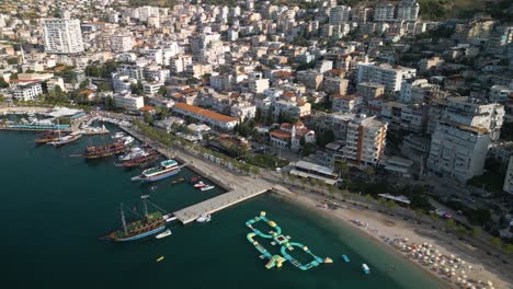 cinematic aerial view of downtown saranda, albania on typical summer day