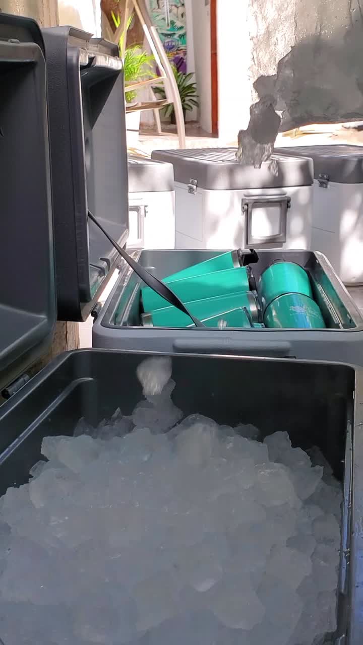 Close-up of a cooler being filled with ice, showcasing the preparation ...
