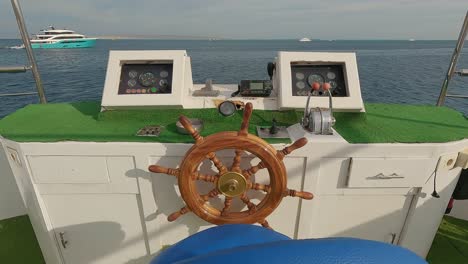 steering wheel and navigation compass on a yacht background of red sea