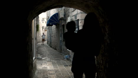 mother and child silhouette in an old town alley