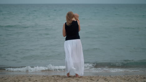 Mother-with-baby-daughter-looking-at-the-sea