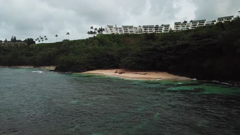 Aerial-view-approaching-a-Secret,-Private-Resort-Beach-in-Kauai,-Hawaii