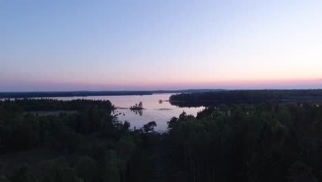 Aerial-of-a-lake-and-forest-at-dawn-in-Finland