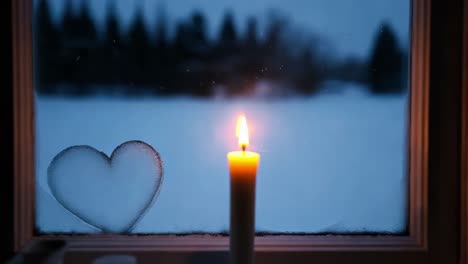 candlelight by the frozen window in winter