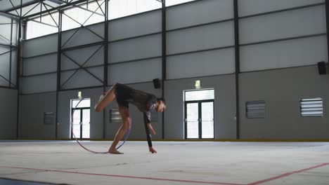 female gymnast performing at sports hall