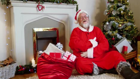 Santa-claus-sitting-fireplace-and-singing