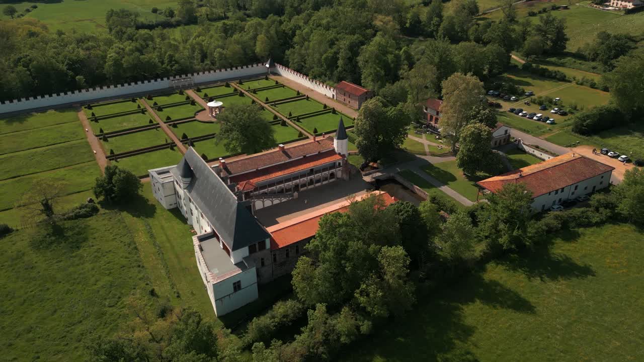 aerial shot around the batie d'urfe castle revealing the landscape of the forez plain in loire departement on a sunny day, auvergne rhone alpes region, france