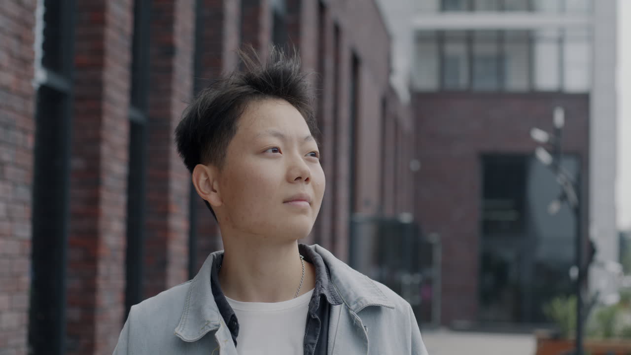 Person looking away in city street