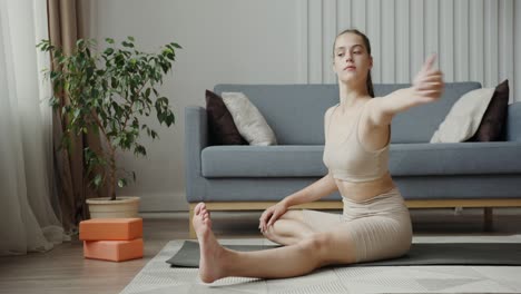 young woman stretching on a yoga mat