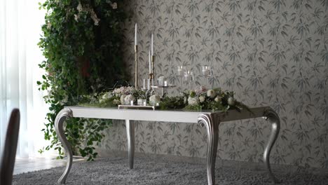 elegant dining setup with floral wallpaper and decorative plants