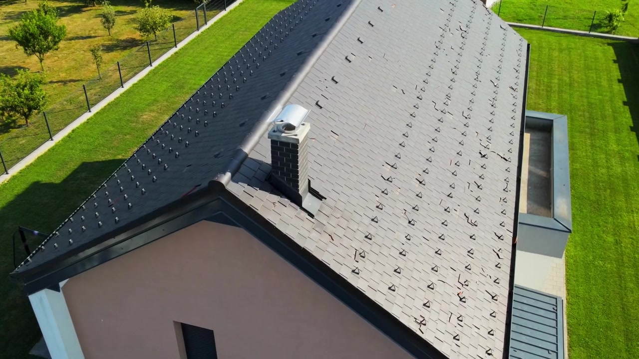 Drone 4k footage of solar panels on a house roof severely damaged by a recent hailstorm. Captures the fragility of renewable energy systems under extreme weather conditions. Climate change theme video