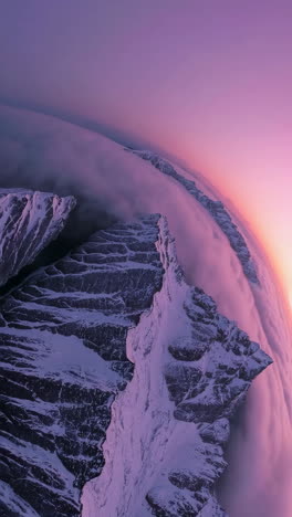 majestic mountain peaks piercing the clouds at sunrise