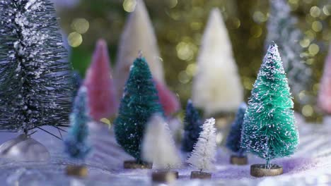 slow motion snow glitter falls on bottlebrush trees with blue and gold bokeh background