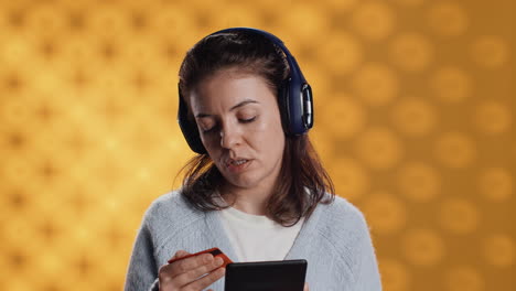 woman reading ebook, listening music, purchasing books, studio background