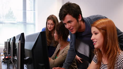 estudiantes trabajando juntos en la sala de computadoras