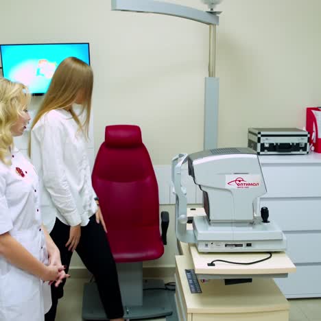 ophthalmologist examining young woman