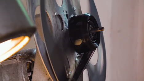 large-spool-with-film-reel-rotates-by-old-cinema-equipment