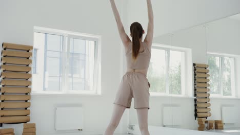 young woman doing yoga in studio