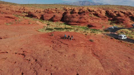 Three-Young-Tourists-Sitting-On-A-Red-Hill-Enjoying-The-View-At-Pioneer-Park-St