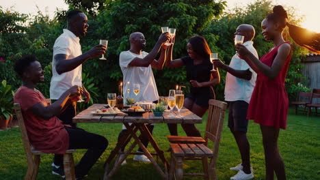 friends enjoying a toast at a sunset garden party
