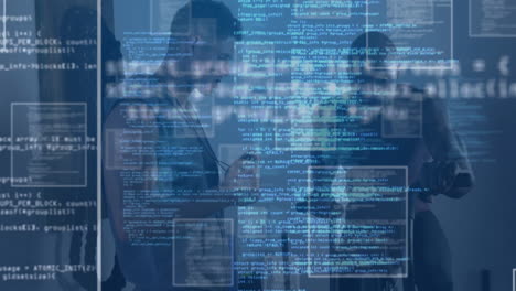 Business associates holding laptop facing each other in technology, showcasing floating code panels