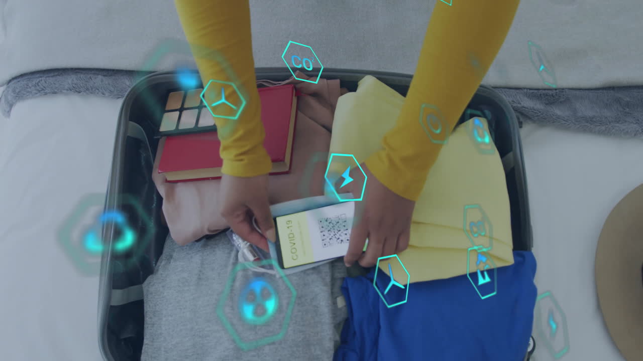 Traveler packing smartphone into open suitcase on bed, showing AR travel tech and health icons