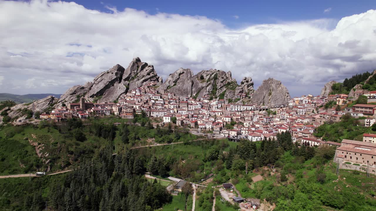 Aerial view of Italian village Pietrapertosa on top of rocky mountain range on a sunny day