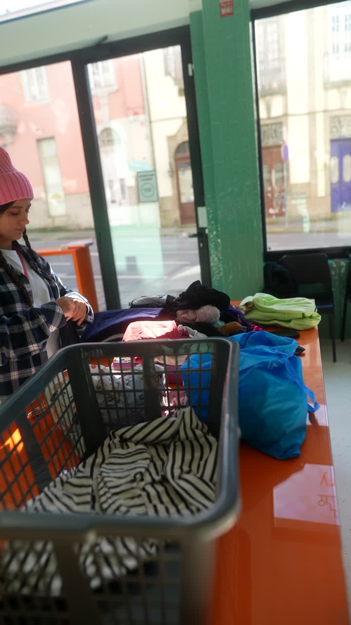 Adolescente volontario in un centro di donazione di vestiti