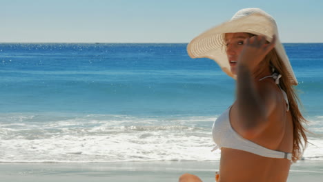 beautiful woman putting on sunscreen at beach