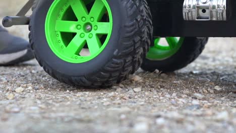 close up shot on parts of rc monster truck toy, moving on soil ground 120fps