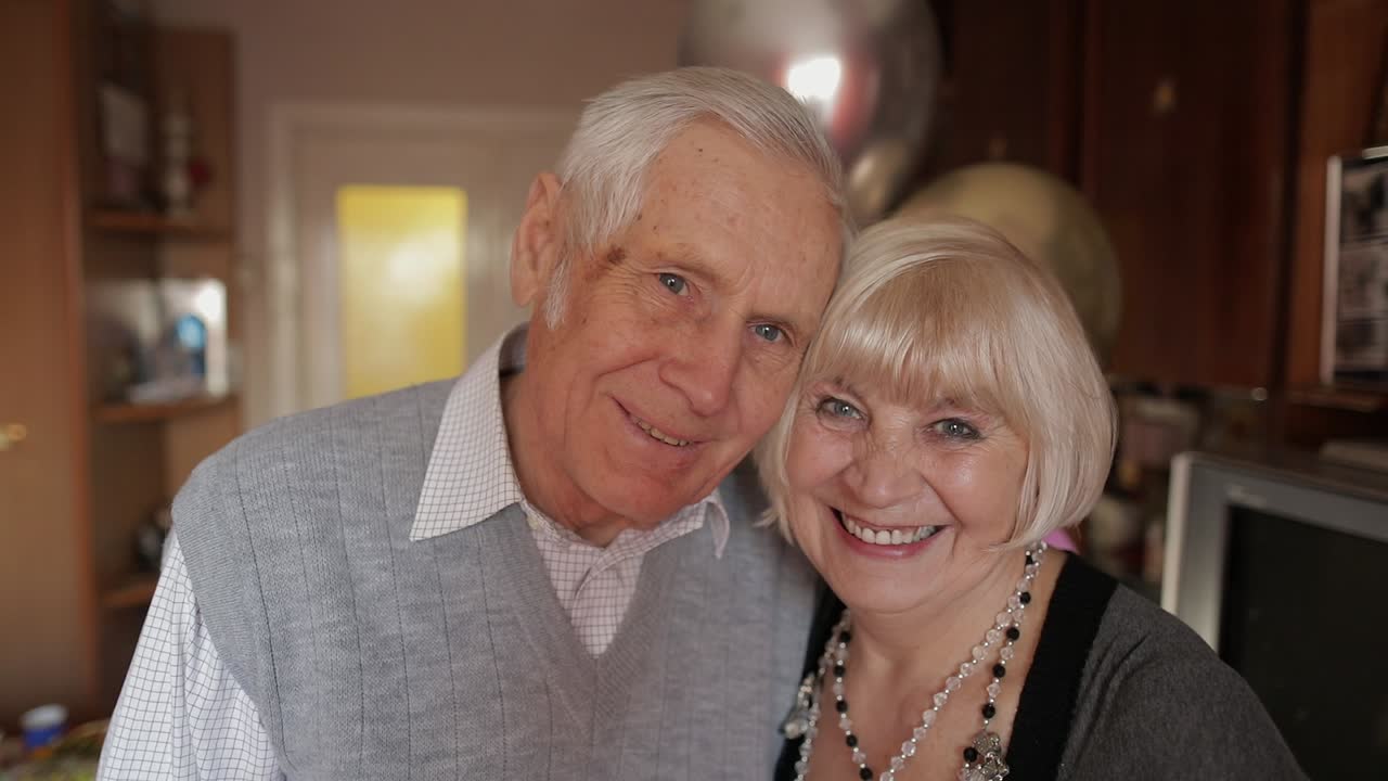 Portrait of a happy grandfather and grandmother who smiling looks at camera