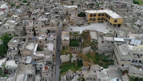 drone flying over houses in aleppo under a cloudy sky. we can see the buildings and houses of the syrian city in ruins after the war 4k