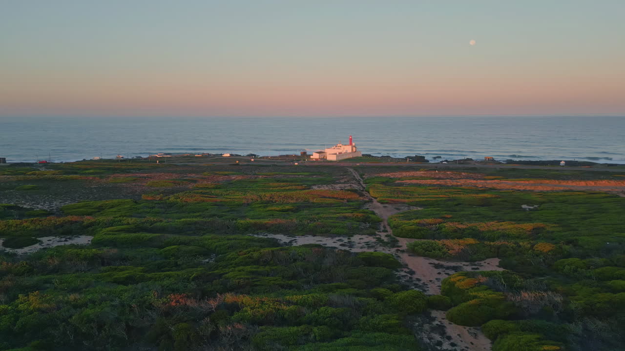 Beautiful evening sea landscape drone view. Light pink sky over endless ocean.