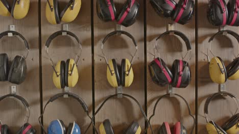 Tilt-up-of-hearing-protection-ear-muffs-hanging-on-a-wall