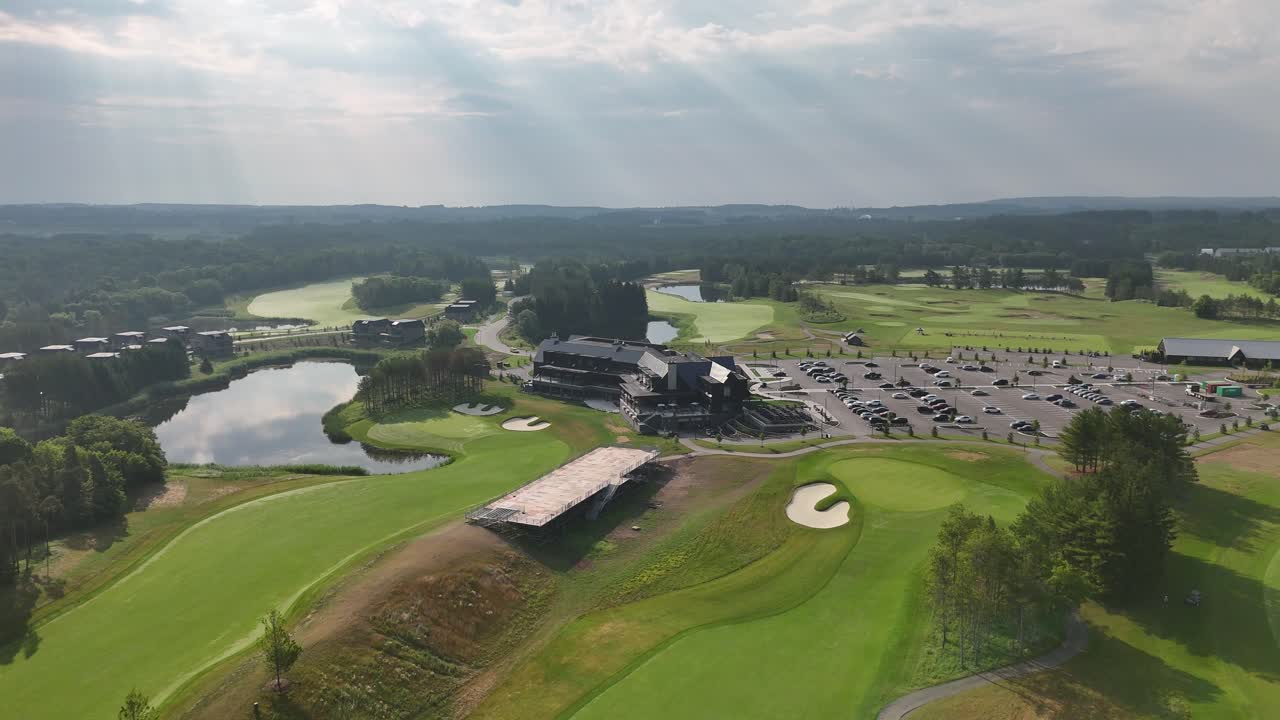 Picturesque of lush, mowed, and well-trimmed fairways of TPC Toronto Osprey Valley Golf Course in Alton, Caledon, Ontario, Canada, on cloudy day