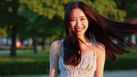 smiling woman in a park at sunset