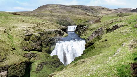 Iceland - Adventurous hiker explores the mesmerizing Skoga River in Iceland&#039;s captivating waterfall way hike