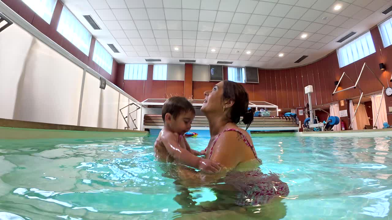 Mother and Baby Swimming in a Pool