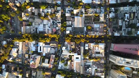 aerial top down truck right over santiago city residential area houses and traffic in avenues at golden hour, chile