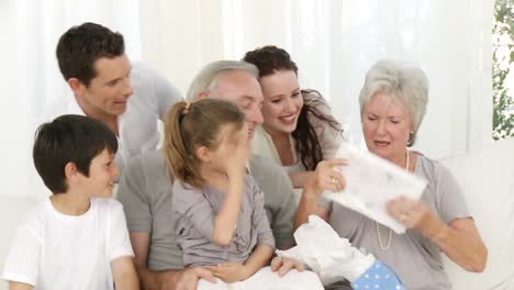 family giving a present to the grandmother