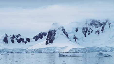 Antarctica-Winter-Mountains-on-Coast,-Coastal-Landscape-Scenery-in-Antarctic-Peninsula,-Cold-Blue-Scene-with-Glacier-Ice-and-Southern-Ocean-Sea-Water,-Mountain-Seascape-in-Beautiful-Dramatic-Scene