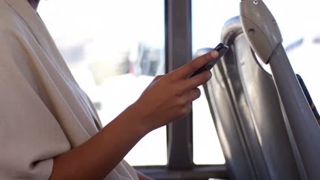 Female-commuter-using-mobile-phone-while-travelling-in-bus-4k