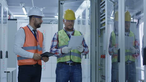 engineers inspecting equipment in a data center