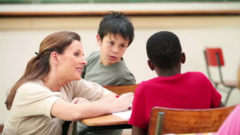 smiling teacher talking with a pupil