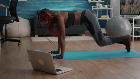 Fit black woman in sportswear doing workout burning fat calories training body muscles