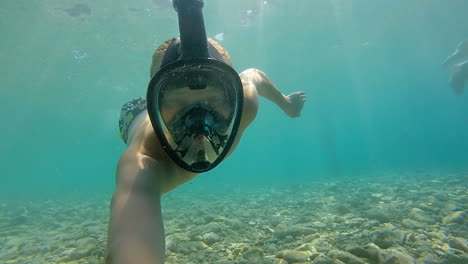 The-boy-swims-underwater-in-a-diving-mask