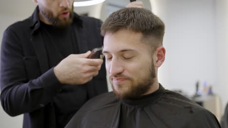 man getting a haircut at the barber shop