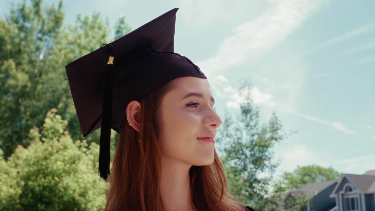 A female graduate student looks on thoughtfully with a pleasant look.