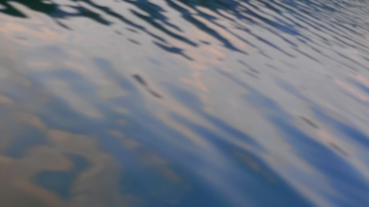 Water flies by as boat drives through calm ocean